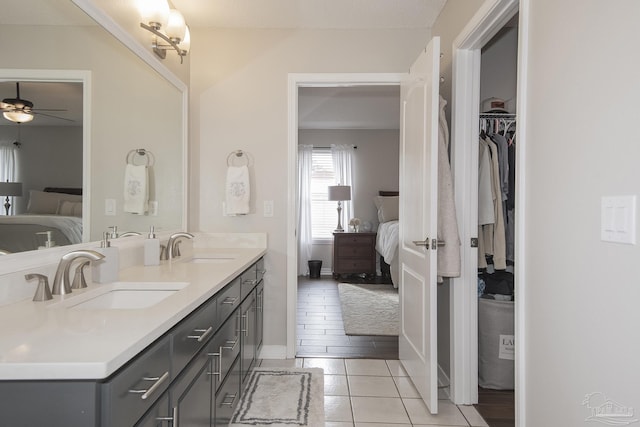 bathroom with ceiling fan, vanity, and tile patterned flooring