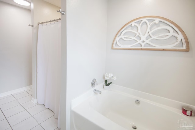 bathroom with a bath and tile patterned floors