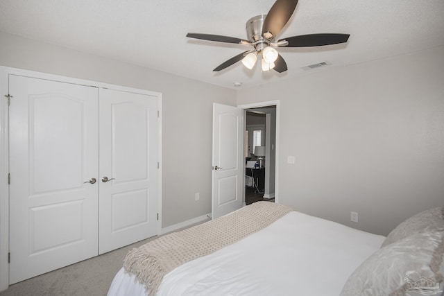 bedroom featuring visible vents, a ceiling fan, carpet, a textured ceiling, and a closet