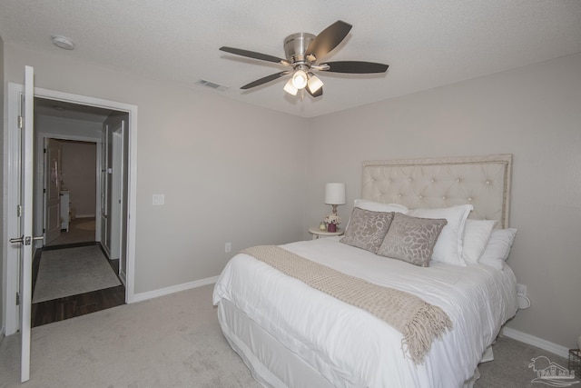 bedroom with visible vents, carpet flooring, ceiling fan, a textured ceiling, and baseboards