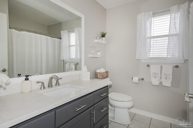 full bath featuring toilet, vanity, baseboards, and tile patterned floors