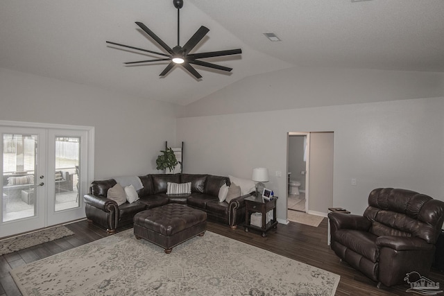 living room with lofted ceiling, dark hardwood / wood-style floors, and french doors