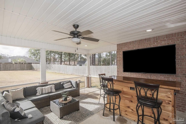 view of patio with ceiling fan, outdoor dry bar, fence, and an outdoor living space