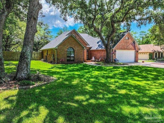 2574 1st Ct, Navarre, FL 32566 - view of front facade with brick siding, an attached garage, and driveway