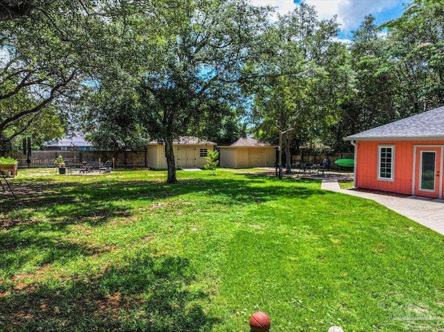 2574 1st Ct, Navarre, FL 32566 - view of yard featuring an outdoor structure and a patio