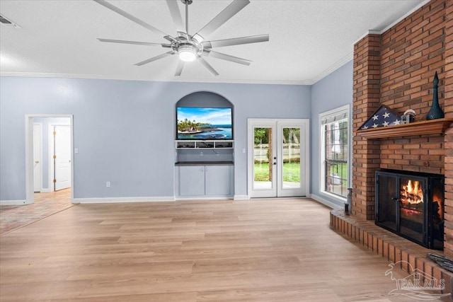 2574 1st Ct, Navarre, FL 32566 - unfurnished living room featuring crown molding, light wood-style floors, a fireplace, ceiling fan, and baseboards