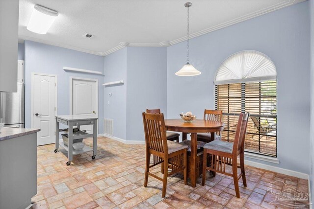 2574 1st Ct, Navarre, FL 32566 - dining area with brick patterned floors, baseboards, and ornamental molding