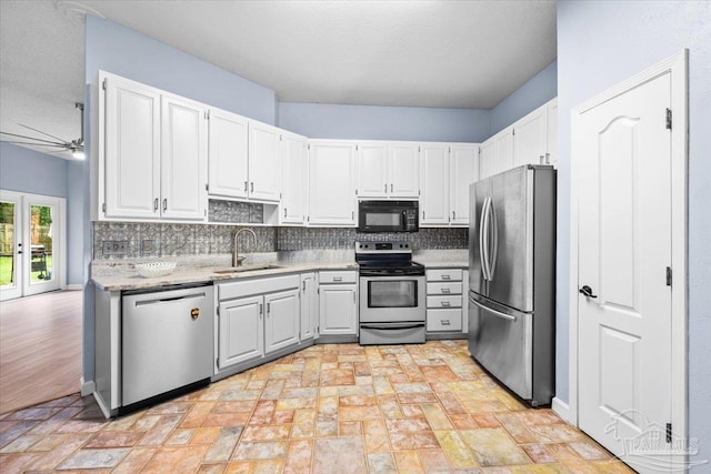 2574 1st Ct, Navarre, FL 32566 - kitchen featuring stainless steel appliances, a sink, decorative backsplash, and a ceiling fan