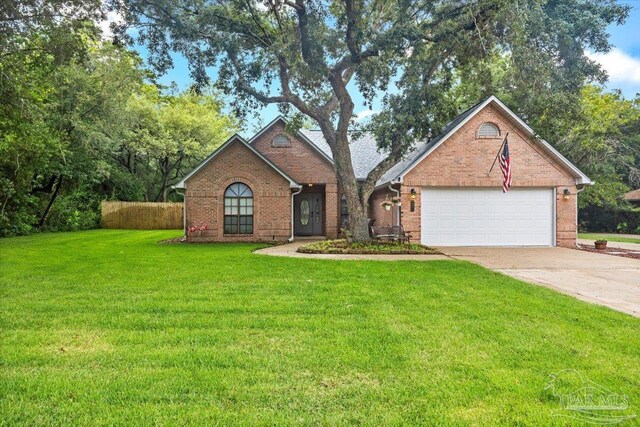 2574 1st Ct, Navarre, FL 32566 - view of front of house featuring brick siding, driveway, and a garage