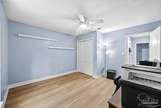 2574 1st Ct, Navarre, FL 32566 - interior space with light wood-type flooring, ceiling fan, baseboards, and a textured ceiling