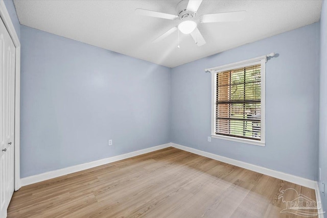 2574 1st Ct, Navarre, FL 32566 - spare room featuring light wood-type flooring, baseboards, and a ceiling fan