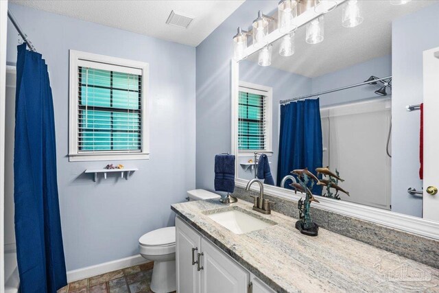 2574 1st Ct, Navarre, FL 32566 - full bath with vanity, toilet, baseboards, a shower with curtain, and stone finish flooring