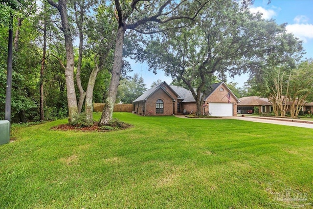 2574 1st Ct, Navarre, FL 32566 - view of front of house with driveway, a garage, and brick siding