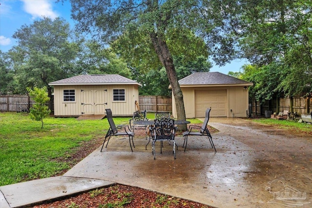 2574 1st Ct, Navarre, FL 32566 - view of patio featuring an outdoor structure, a garage, and driveway