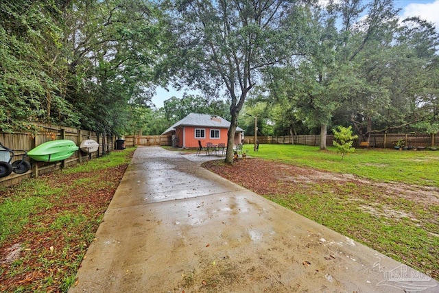 2574 1st Ct, Navarre, FL 32566 - view of yard with concrete driveway and view of scattered trees