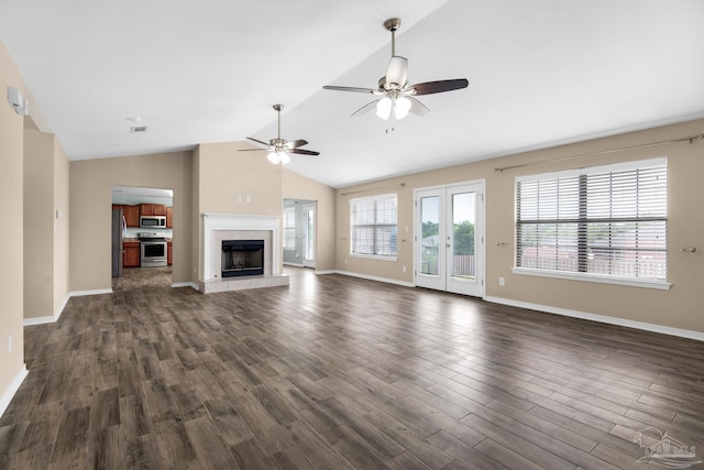 unfurnished living room featuring ceiling fan, a fireplace, dark hardwood / wood-style flooring, and lofted ceiling