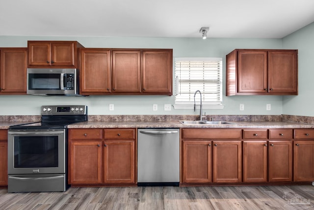 kitchen featuring sink, hardwood / wood-style flooring, and stainless steel appliances