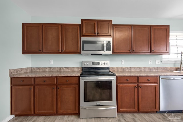 kitchen featuring sink, light hardwood / wood-style flooring, and stainless steel appliances