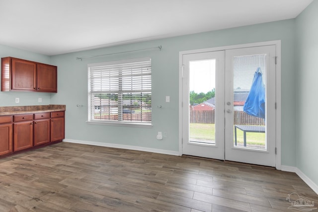 kitchen with french doors and hardwood / wood-style floors