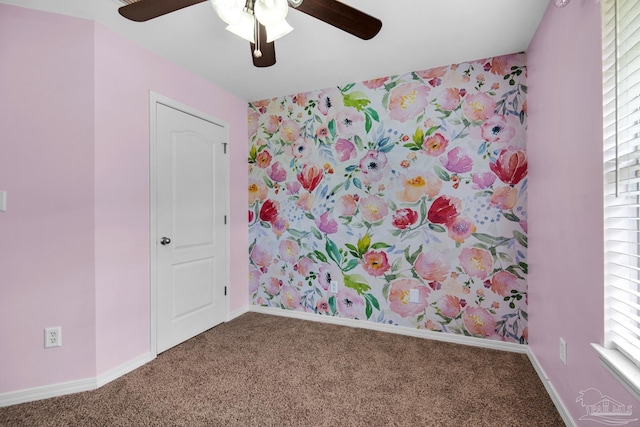 carpeted empty room featuring ceiling fan