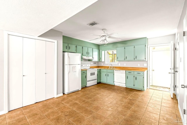 5791 Coronada Blvd Apt 3, Pensacola, FL 32507 - kitchen featuring visible vents, white appliances, green cabinetry, under cabinet range hood, and a sink