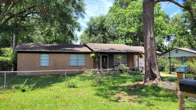 ranch-style home featuring a front yard