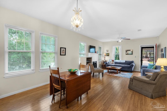 1325 N 15th Ave, Pensacola, FL 32503 - dining area with a fireplace, visible vents, baseboards, hardwood / wood-style flooring, and ceiling fan with notable chandelier
