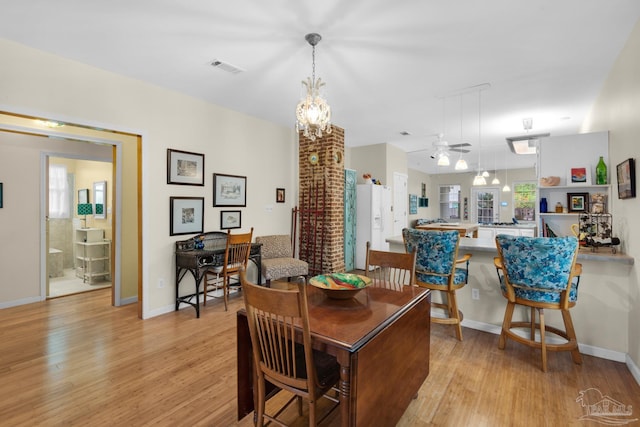 dining room featuring light hardwood / wood-style flooring, a wealth of natural light, and ceiling fan