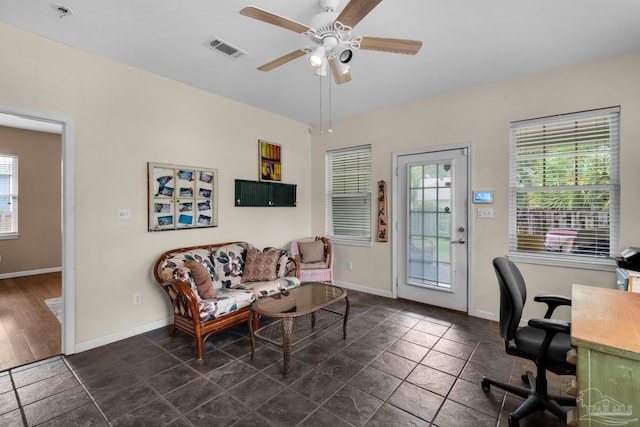 office featuring ceiling fan, plenty of natural light, and dark hardwood / wood-style flooring