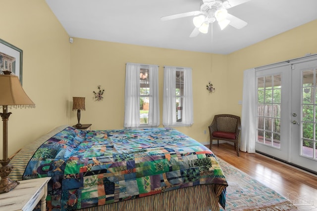 bedroom with ceiling fan, light hardwood / wood-style floors, access to exterior, and multiple windows