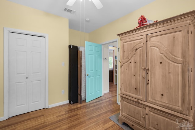 unfurnished bedroom featuring a closet, ceiling fan, and hardwood / wood-style floors