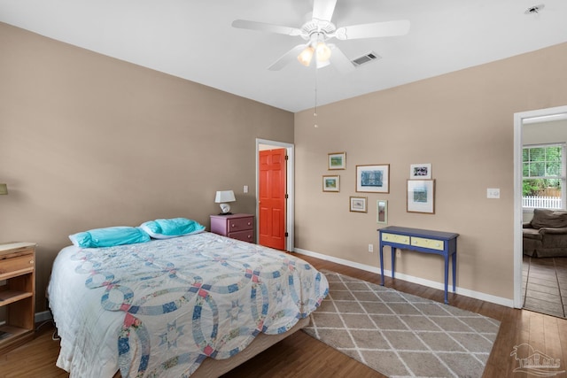 bedroom with ceiling fan and dark wood-type flooring