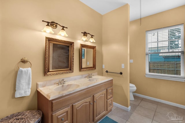 bathroom featuring tile patterned flooring, vanity, and toilet