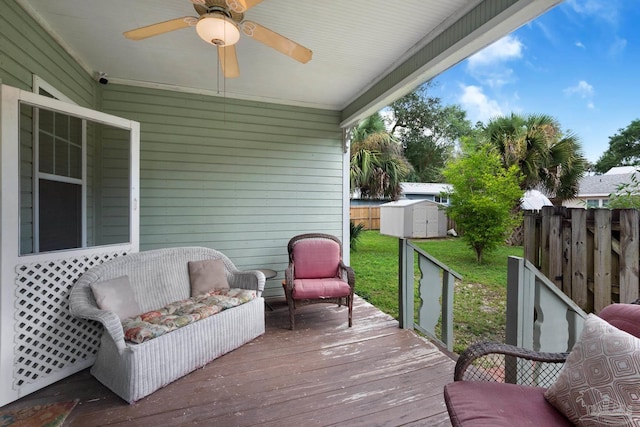 1325 N 15th Ave, Pensacola, FL 32503 - wooden deck with a fenced backyard, a yard, ceiling fan, an outbuilding, and a shed