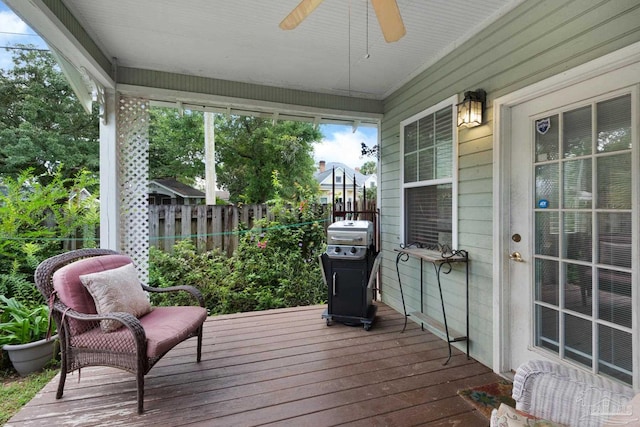 wooden terrace featuring grilling area and ceiling fan