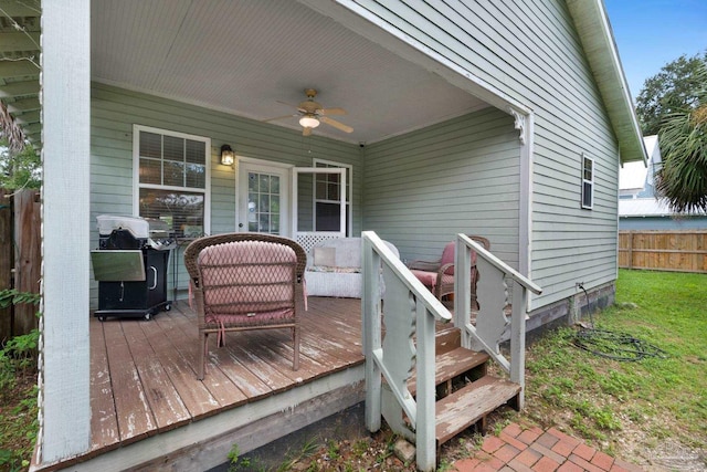 wooden terrace with area for grilling and ceiling fan