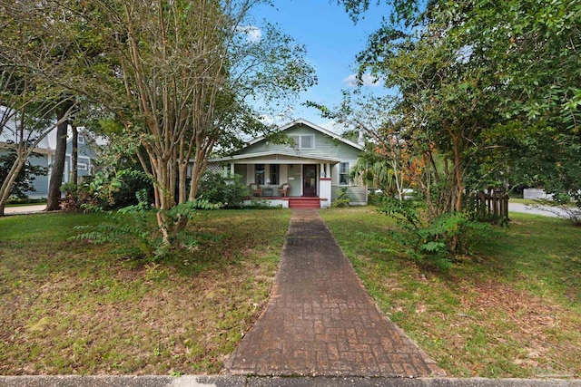 view of front of home featuring a front lawn and covered porch