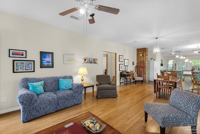 living room featuring ceiling fan and hardwood / wood-style flooring