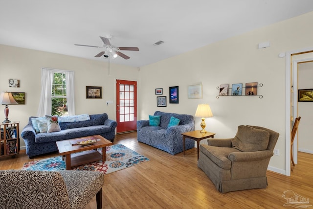 living room featuring ceiling fan and light hardwood / wood-style flooring