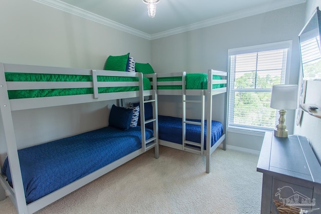 bedroom with baseboards, ornamental molding, and carpet