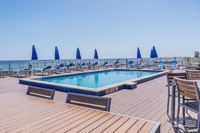 view of swimming pool with fence and a deck