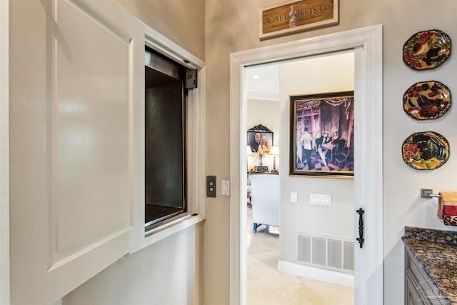 hall with baseboards and visible vents