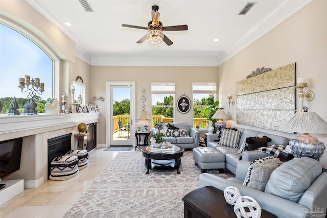 living room with light tile patterned flooring, crown molding, a fireplace, and ceiling fan