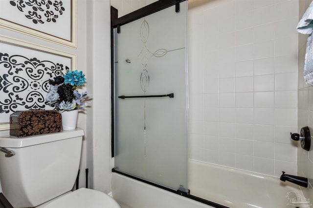 bathroom with enclosed tub / shower combo and toilet