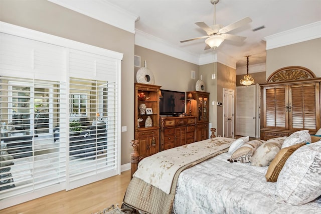 bedroom with crown molding, light hardwood / wood-style flooring, ceiling fan with notable chandelier, and access to outside