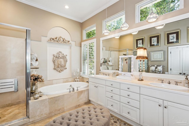 bathroom featuring dual vanity, crown molding, and separate shower and tub