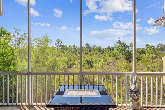 unfurnished sunroom with a wooded view