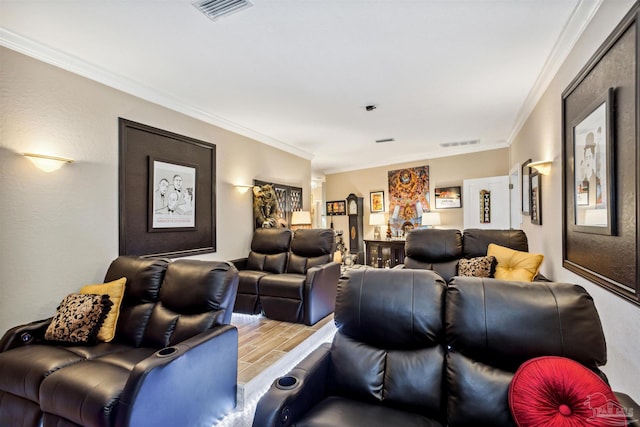 cinema room featuring ornamental molding and light hardwood / wood-style flooring