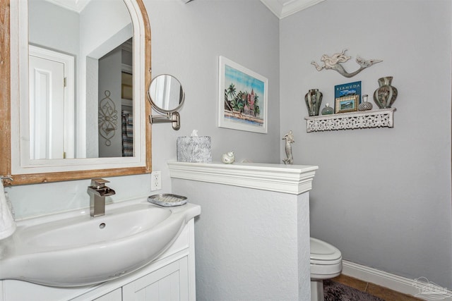 bathroom featuring vanity, toilet, tile patterned floors, and ornamental molding