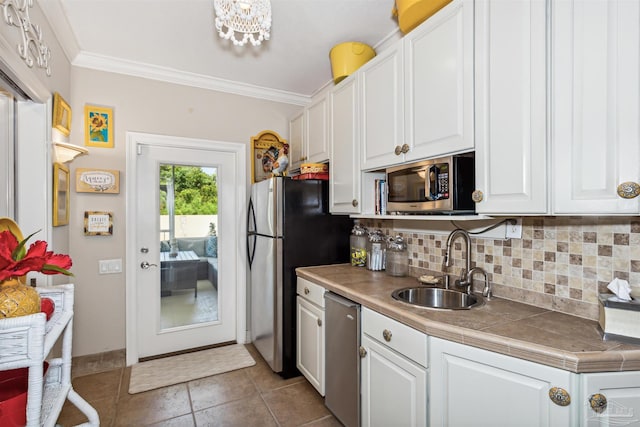 kitchen featuring white cabinets, stainless steel appliances, decorative backsplash, tile countertops, and sink